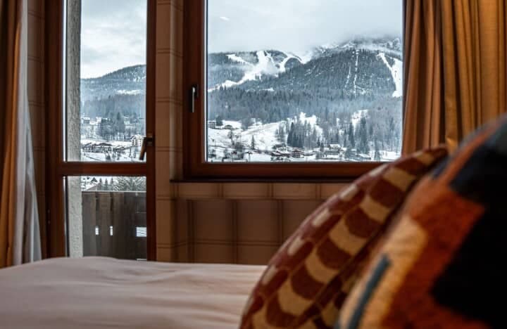 Bedroom view of ski slopes and mountains with balcony access