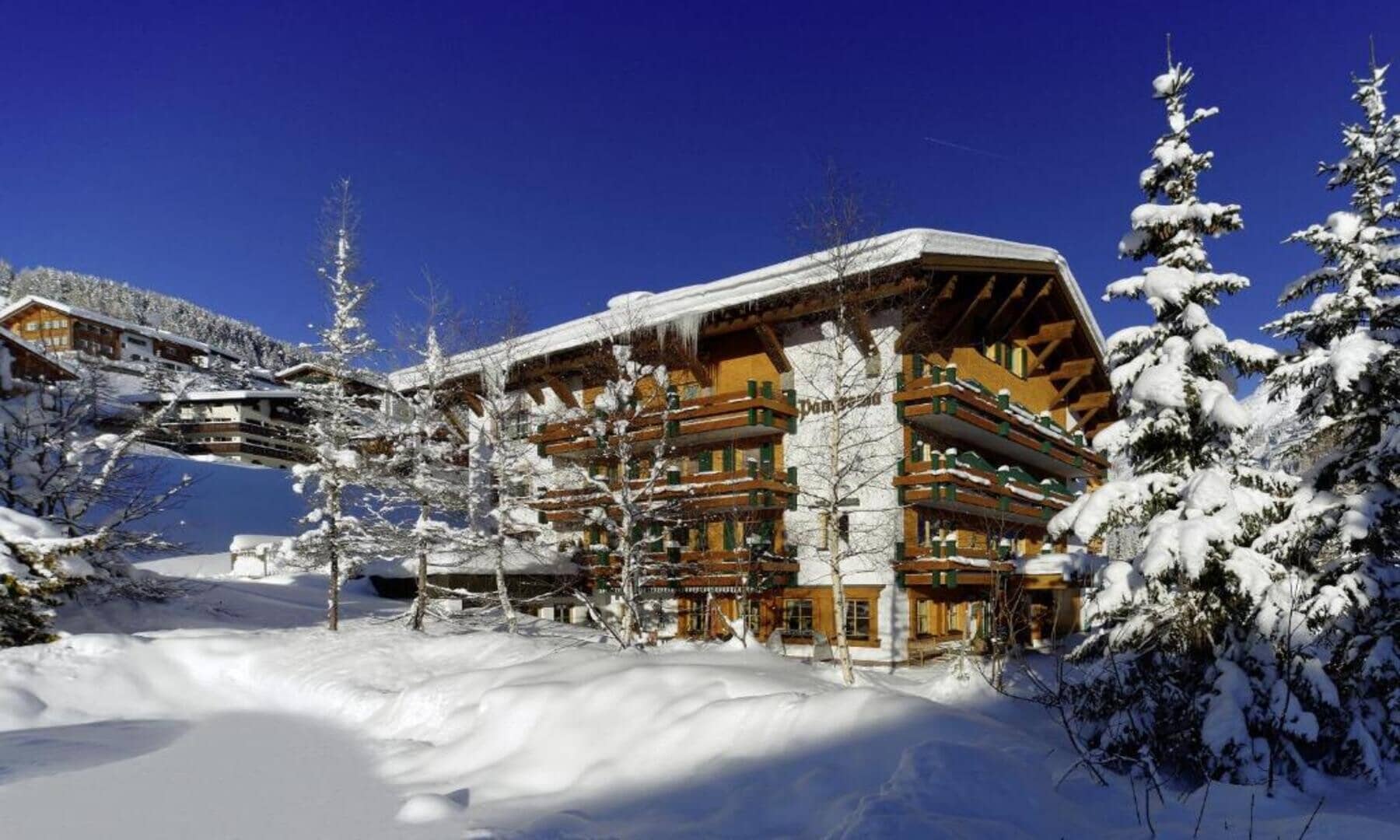 Chalet exterior featuring wrap-around balconies and ski-in access