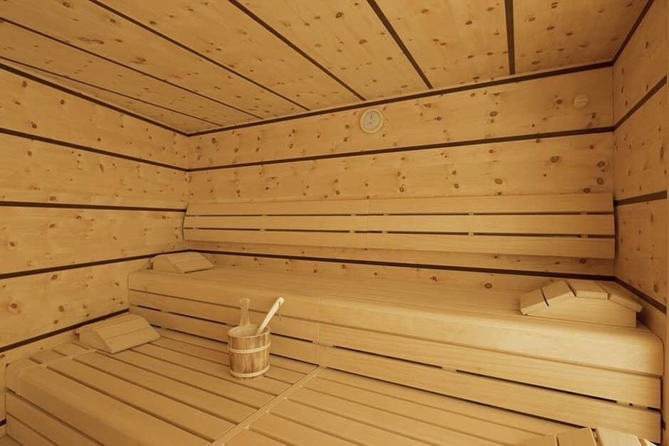 Private cedar sauna with tiered seating and ergonomic headrests