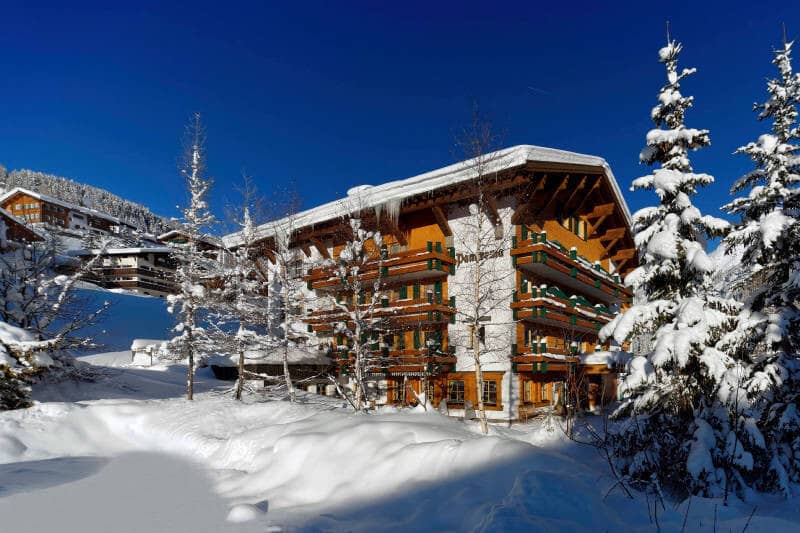 Chalet exterior with multiple private balconies and direct snow access