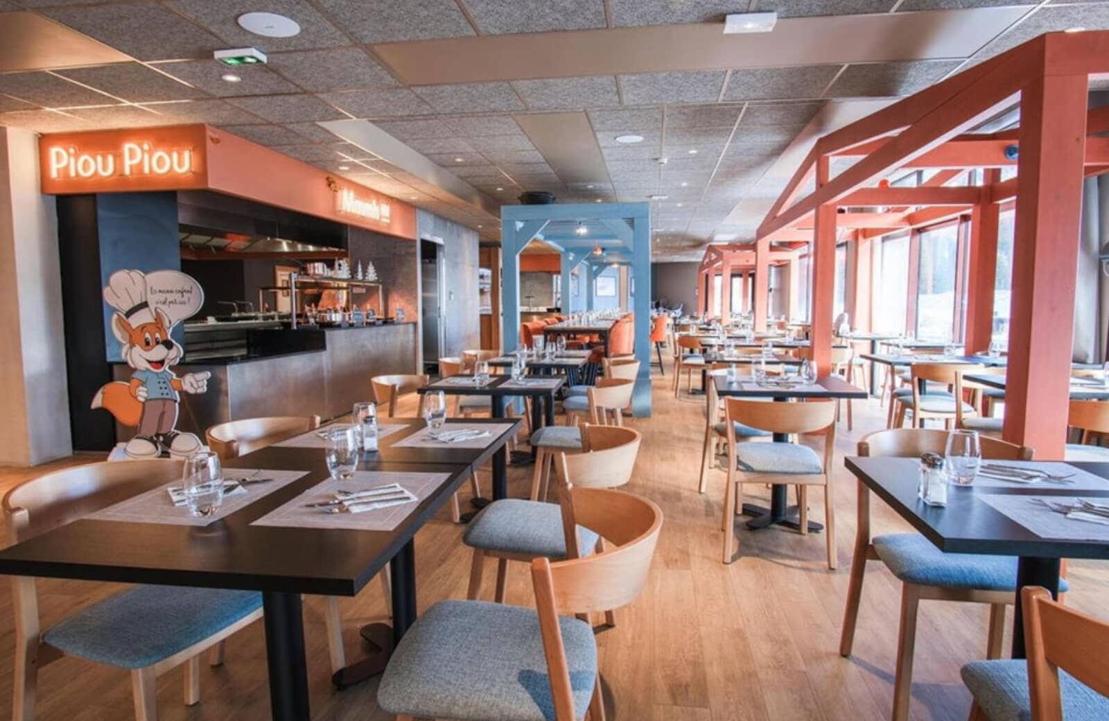 On-site restaurant with large windows and dedicated kids' buffet area