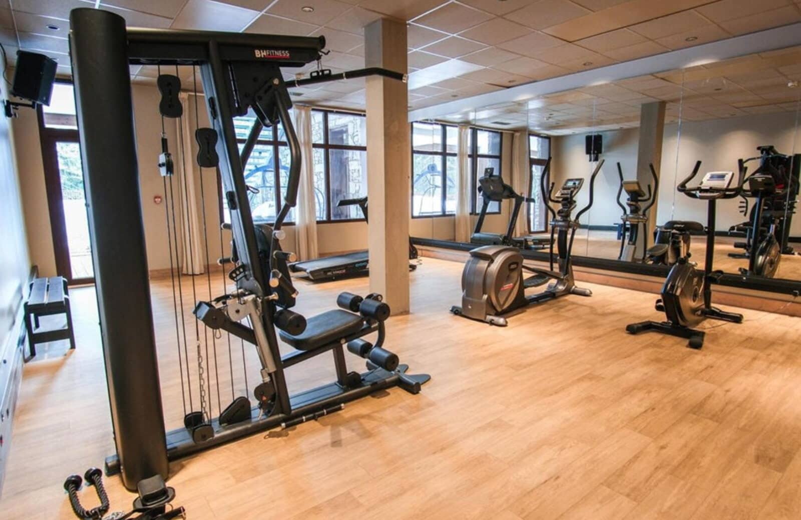 Fitness center with BH Fitness weight machine, treadmill, and elliptical