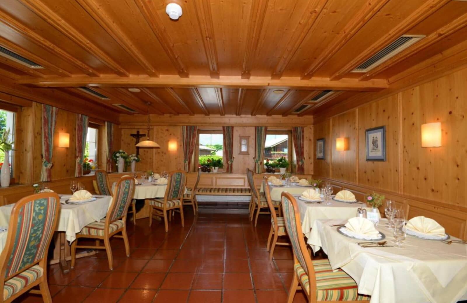 Dining room with wood-paneled walls and banquet seating for groups