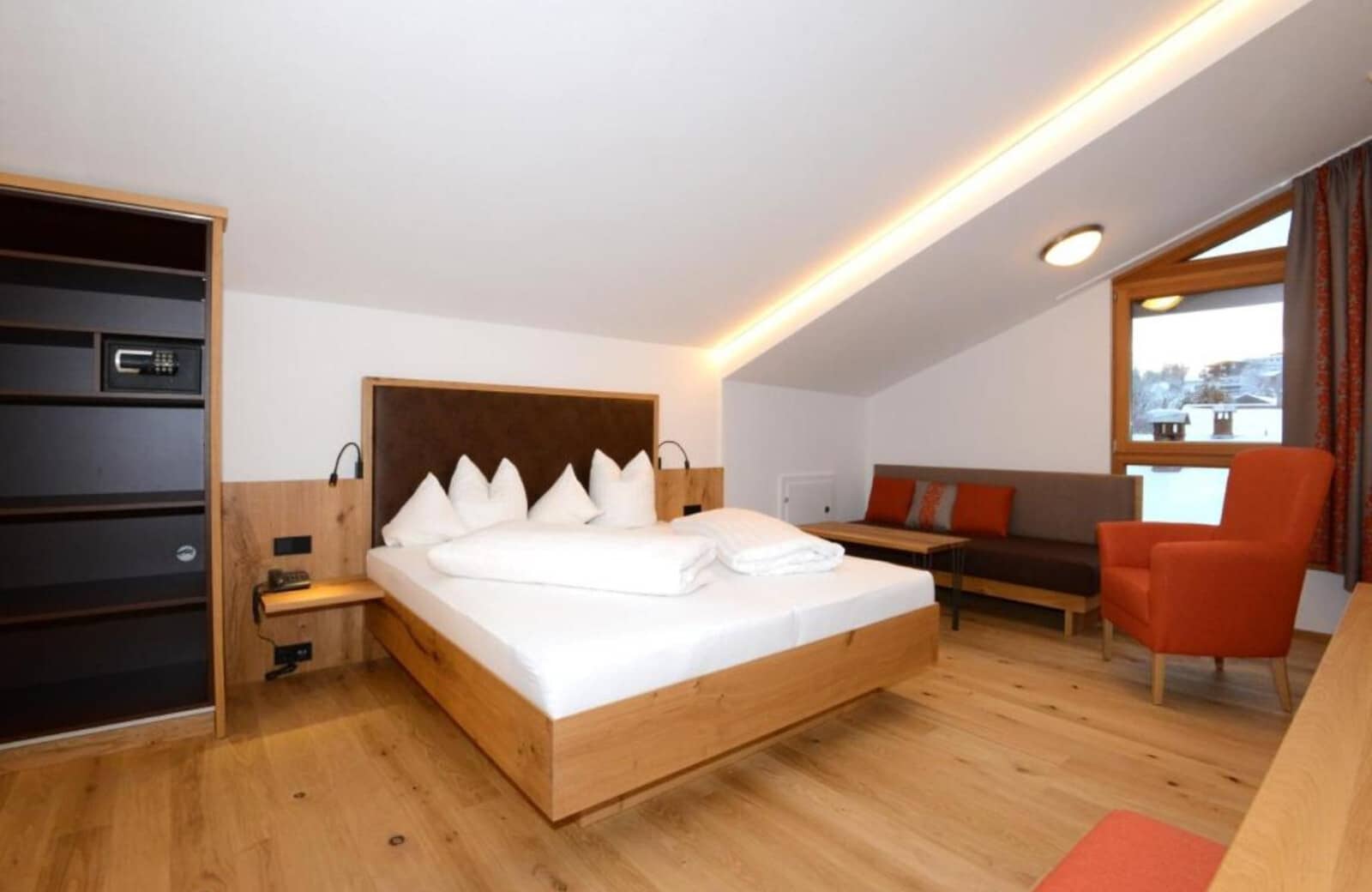 Bedroom with king bed, sofa seating, and built-in safe