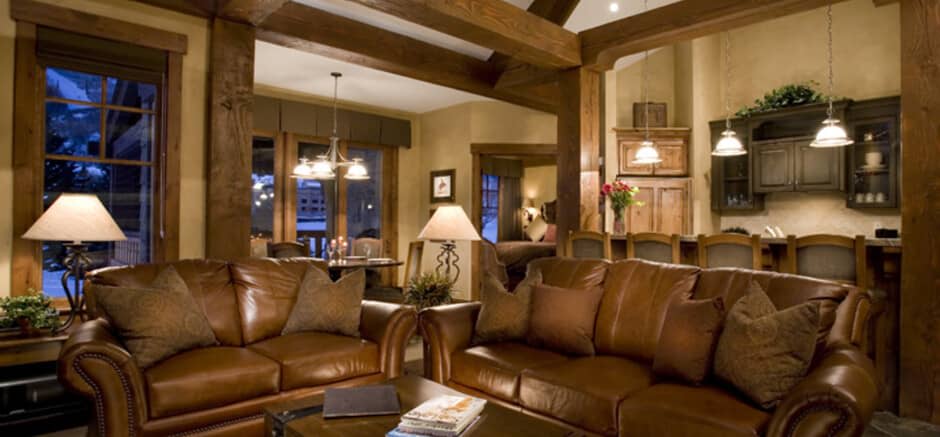 Open-plan living area with leather seating and breakfast bar for four