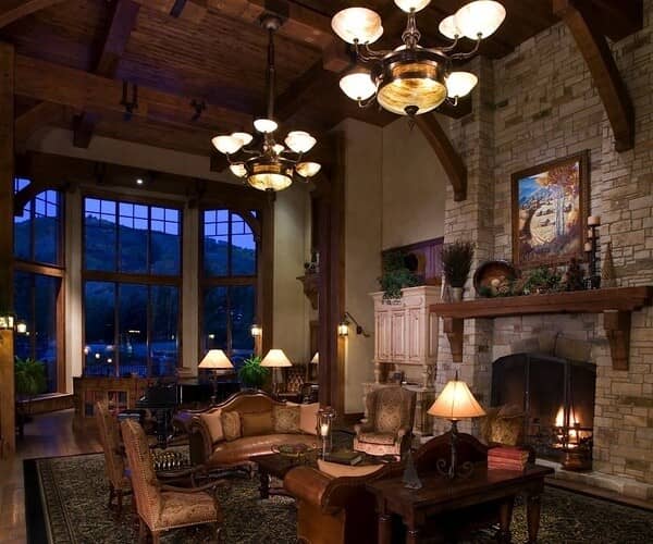 Great room with wood-burning fireplace and floor-to-ceiling mountain views