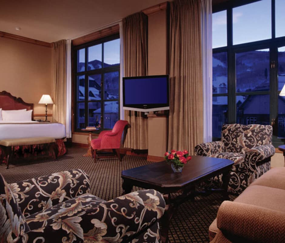 Guest suite with king bed, seating area, and mountain views