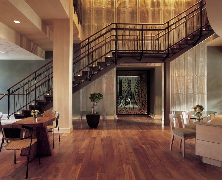 Main lobby with industrial staircase and hardwood flooring