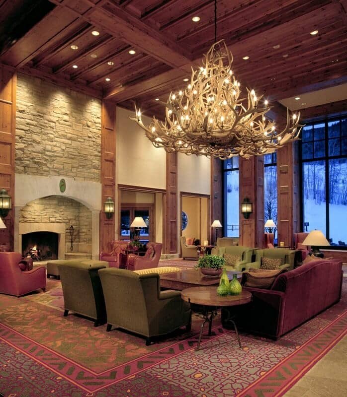 Lounge with wood-burning fireplace and antler chandelier; seating for 12+
