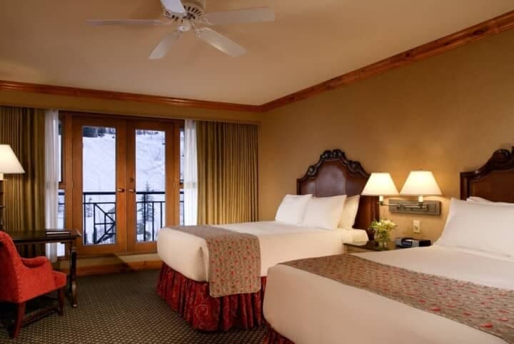 Guest bedroom with two queen beds and private balcony access