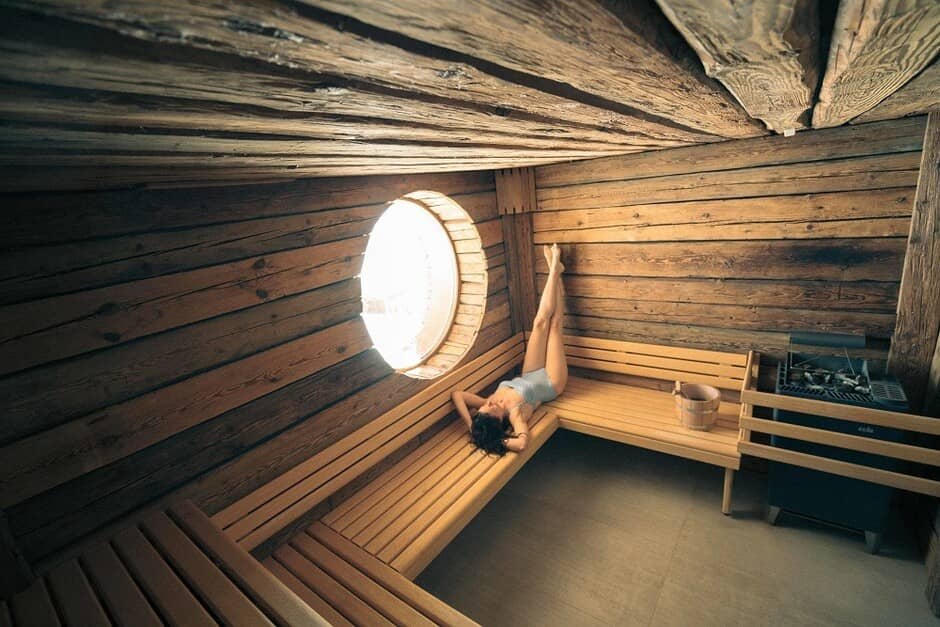 Log cabin sauna with electric heater and porthole window