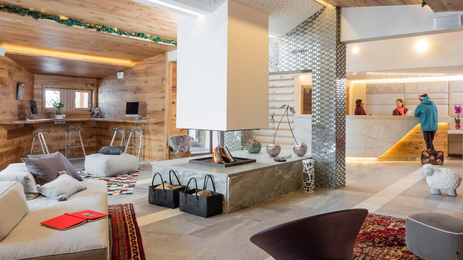 Lobby lounge with central fireplace and shared iMac workstations