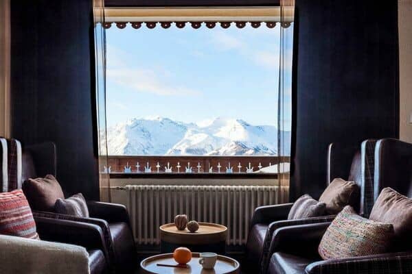 Sitting area with leather wingback chairs and snow-capped mountain views