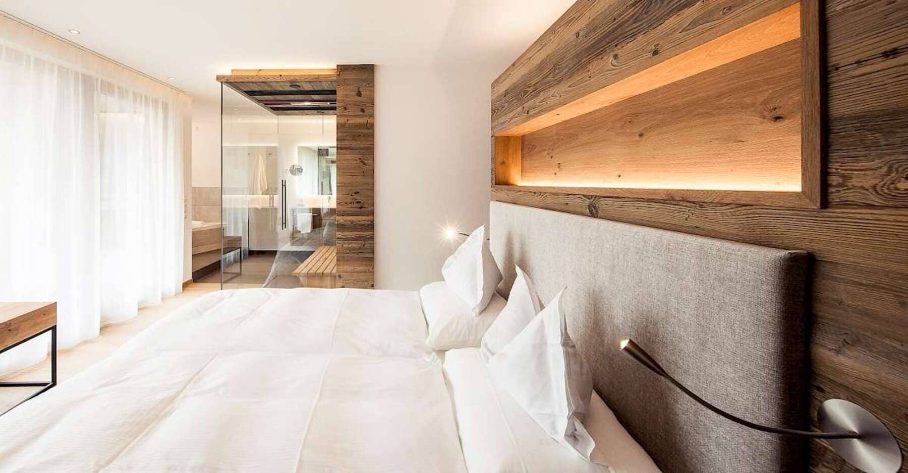 Primary bedroom with king bed and glass-enclosed ensuite bathroom