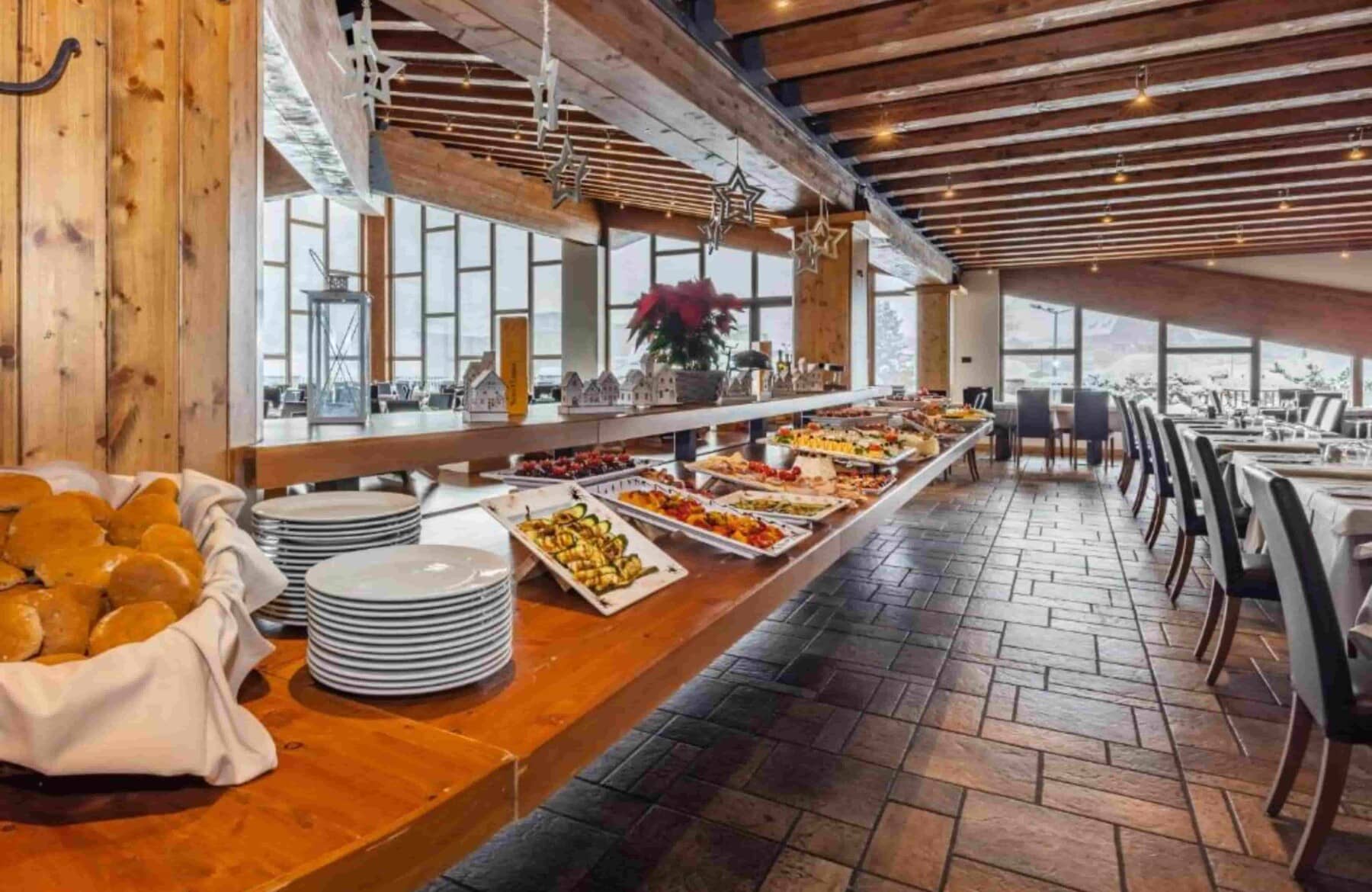 Buffet dining area with floor-to-ceiling windows and mountain views