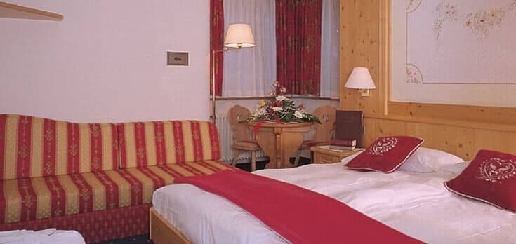 Guest suite with king bed, sofa, and breakfast table for two