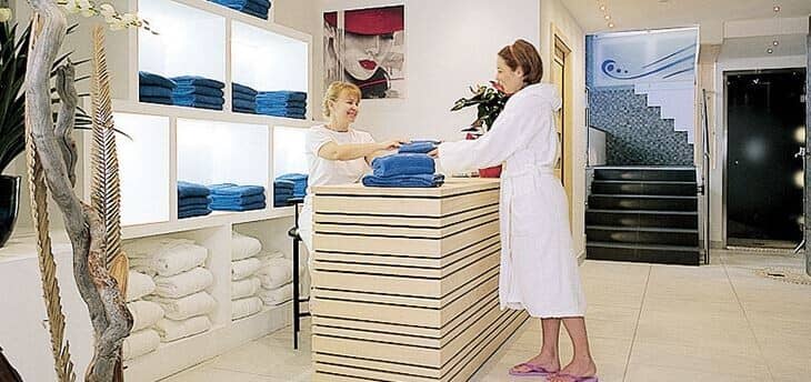 Spa reception area with towel service and adjacent steam room