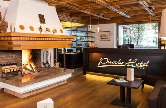 Lobby reception with wood-burning fireplace and coffered ceiling