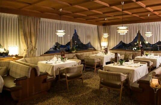 Dining room with coffered wood ceiling and mountain views