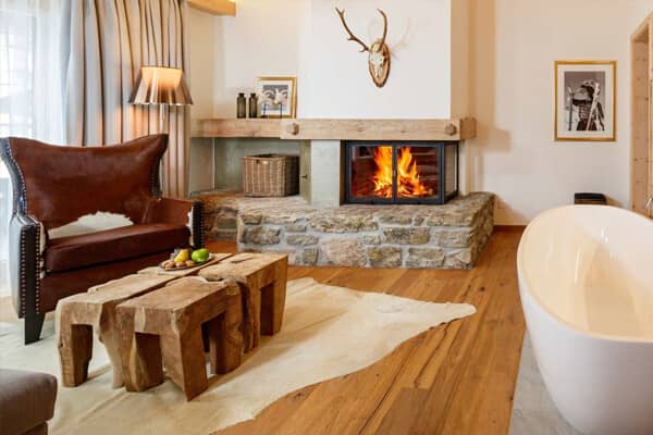 Primary suite featuring wood-burning fireplace and freestanding soaking tub