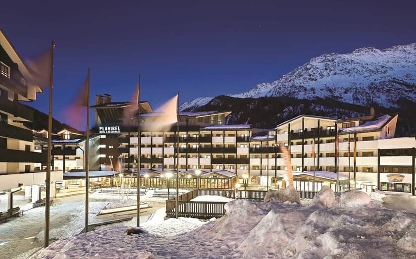 Planibel resort exterior with snow-covered mountain backdrop