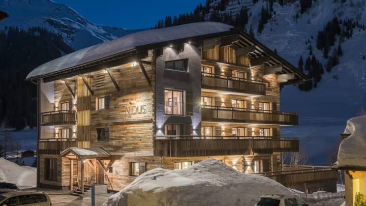 Chalet Nidus exterior with private balconies and mountain views