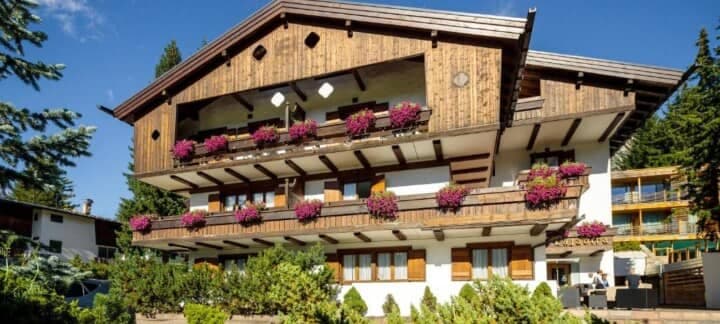 Chalet exterior with multiple private balconies and wood shutters