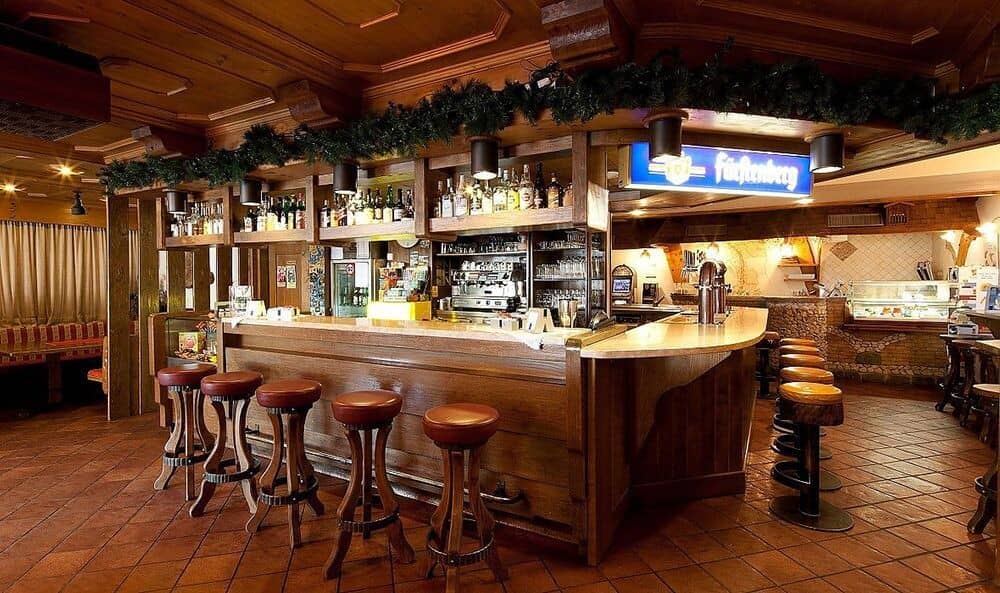 Wood-paneled bar with stool seating for 10 and espresso machine