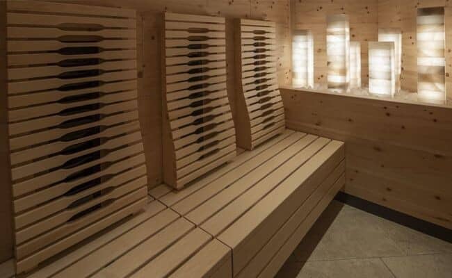 Infrared sauna with ergonomic backrests and salt stone features