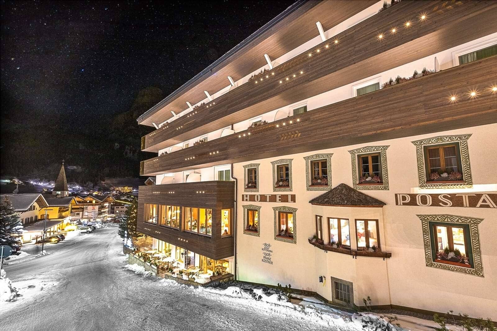 Historic hotel facade in village center with private wooden balconies