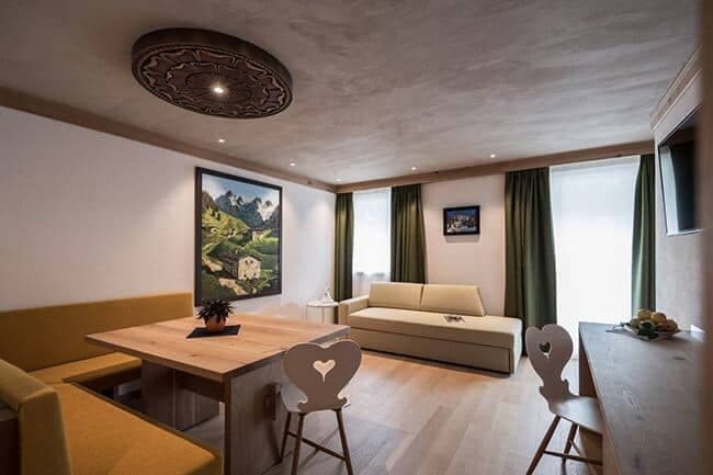 Living area with built-in dining bench and sleeper sofa