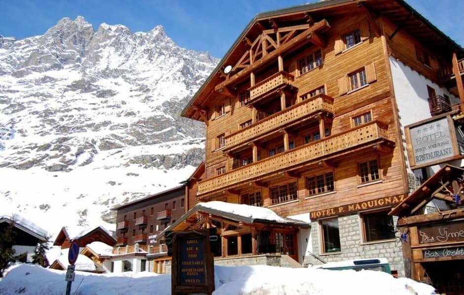 Chalet-style hotel exterior with private balconies and Matterhorn mountain views