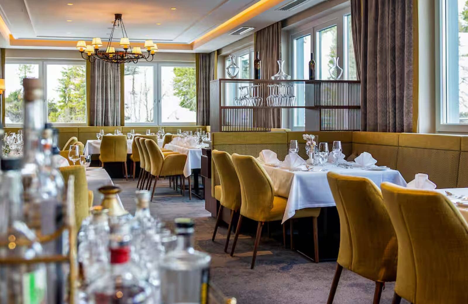 Dining room with banquet seating and glassware display partition