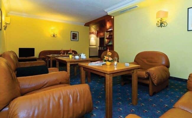Lounge area with leather seating and three individual coffee tables