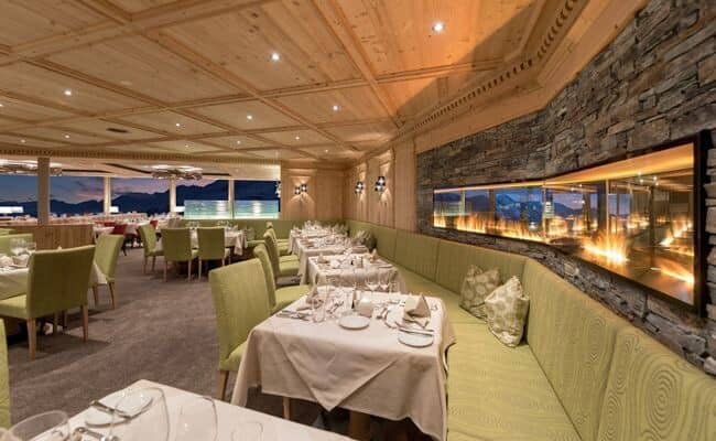 Dining room with linear fireplace and mountain-view windows