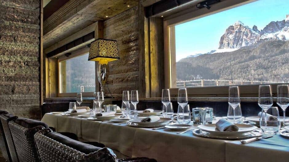 Dining area with reclaimed wood walls and Dolomite mountain views
