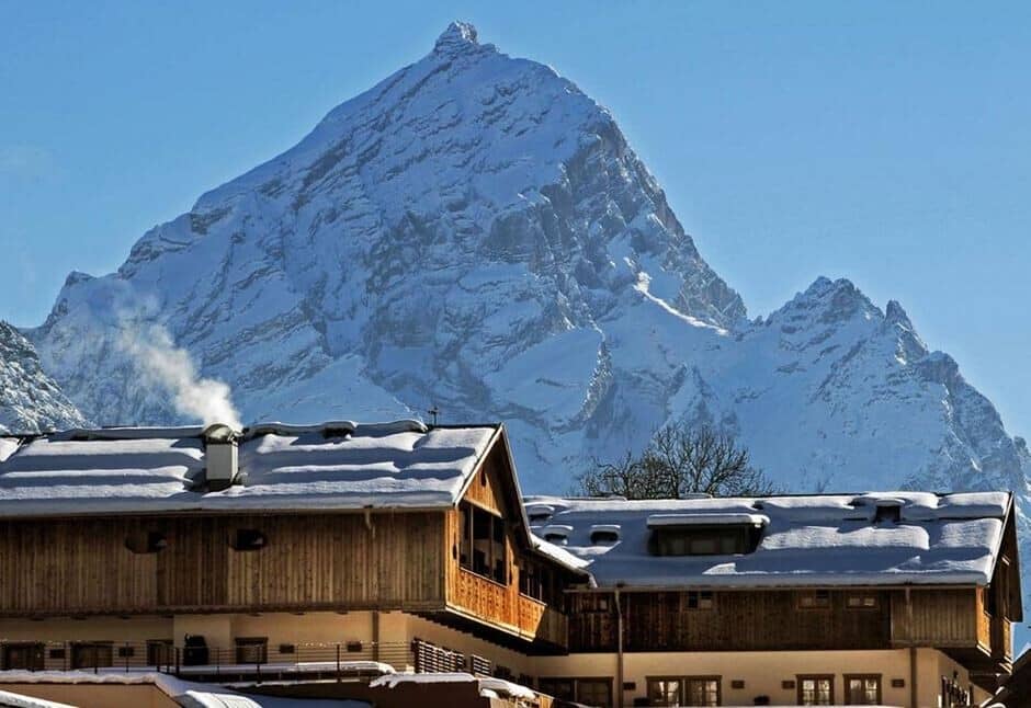 Chalet exterior with timber cladding and direct Alpine mountain views