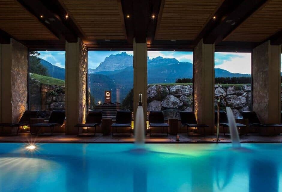 Indoor pool with swan neck jets and mountain peak views