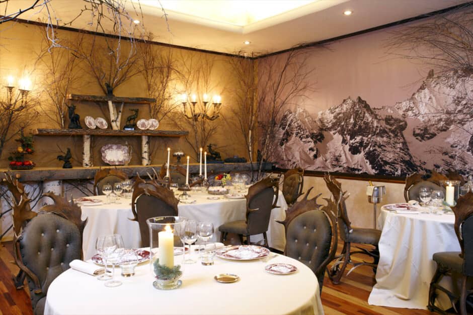 Dining room featuring mountain mural and unique antler-style seating