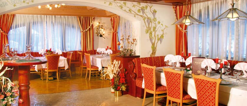 Dining area with booth seating and hand-painted wall murals
