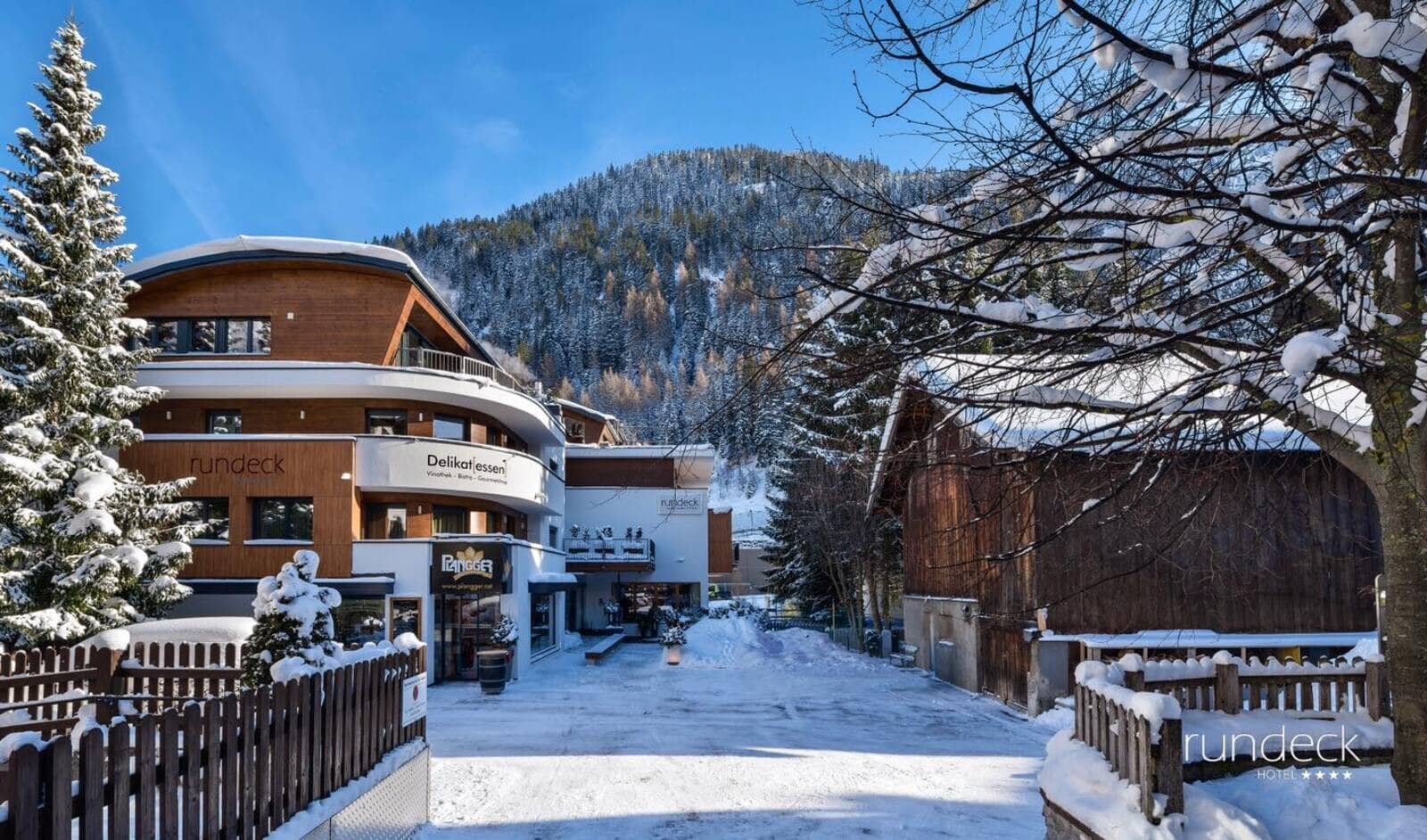 Hotel exterior featuring on-site deli and proximity to mountain slopes