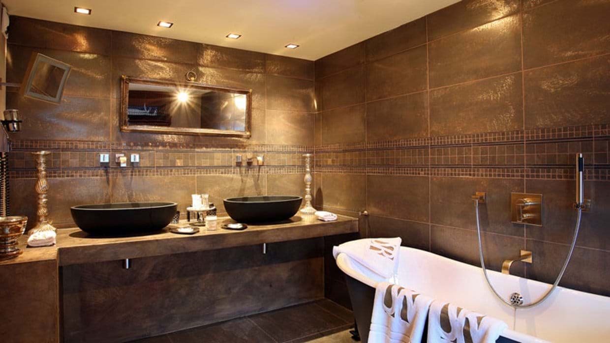 Bathroom with dual vessel sinks and freestanding soaking tub with hand shower