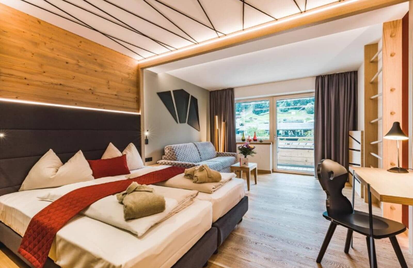 Guest suite with twin-to-king bed, sofa, and private balcony