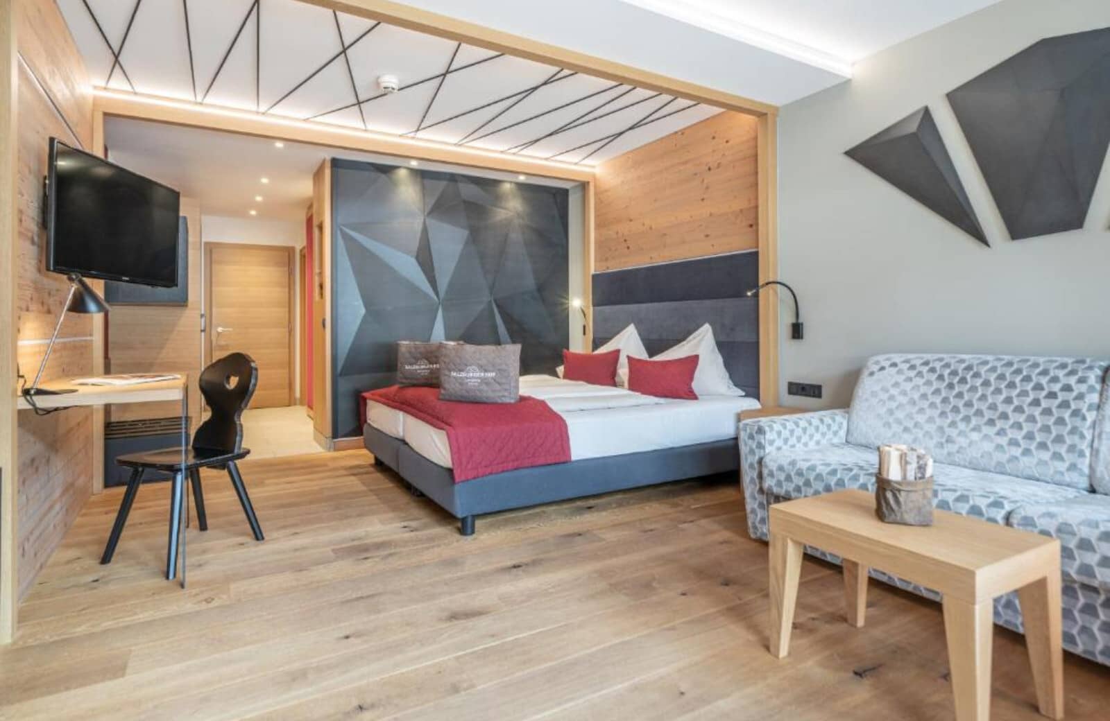 Studio suite with king bed, sofa, and dedicated workspace with desk