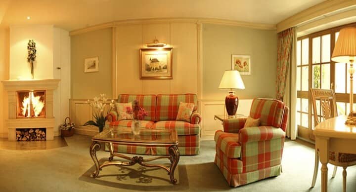 Living room with wood-burning fireplace and balcony access