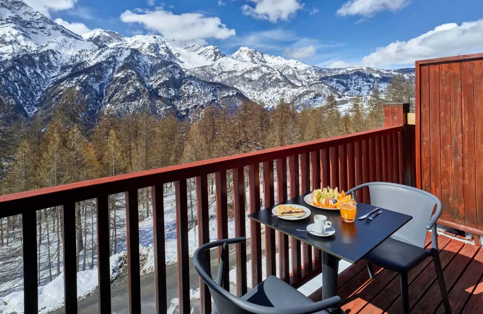 Private balcony seating for two with views of the French Alps