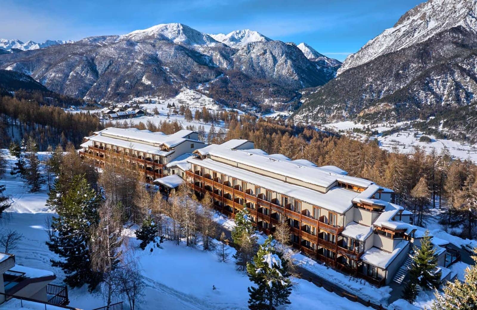 Ski-in/ski-out resort exterior with private balconies and mountain valley views