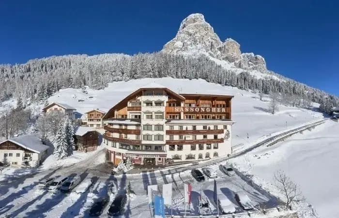 Ski-in/ski-out hotel exterior with Sassongher mountain views and on-site parking