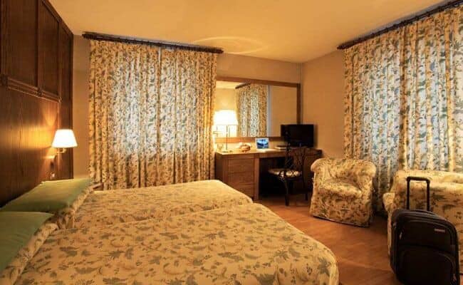 Guest bedroom with two twin beds and dedicated workspace