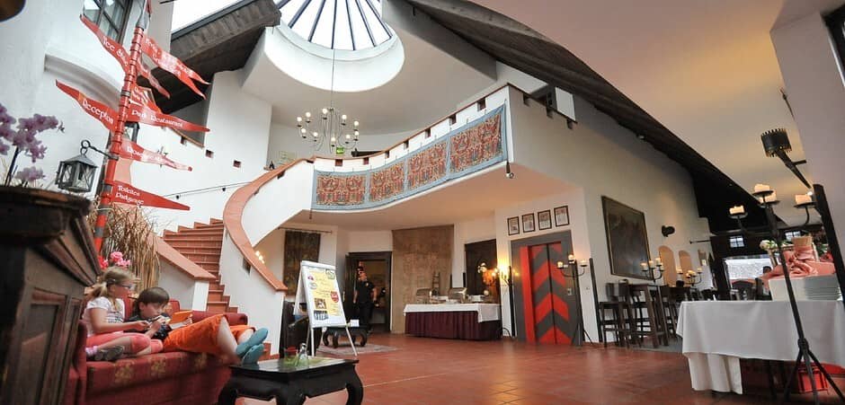Atrium lobby with skylight, guest elevator, and curved staircase